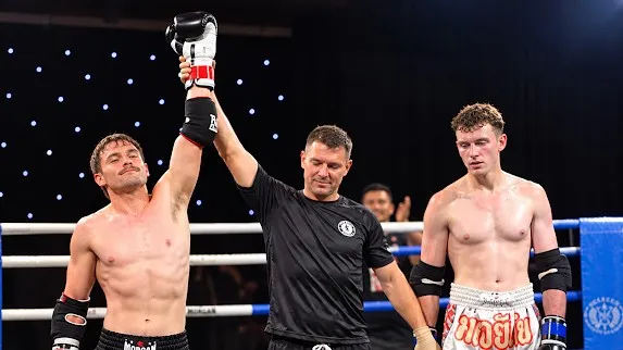 Kalyn having his hand raised by the referee after a first-round TKO win at NQ Beatdown
