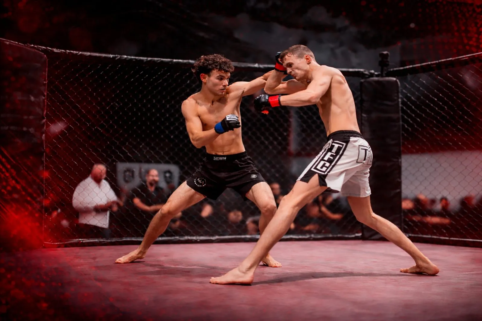 Emile Pancirov landing a straight right in the cage at an MMA fight